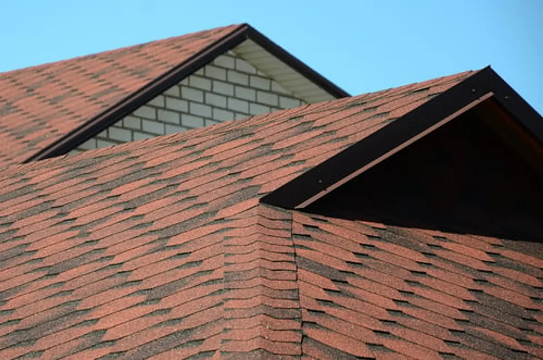 Newly installed shingle roof on a Georgia home against a clear blue sky