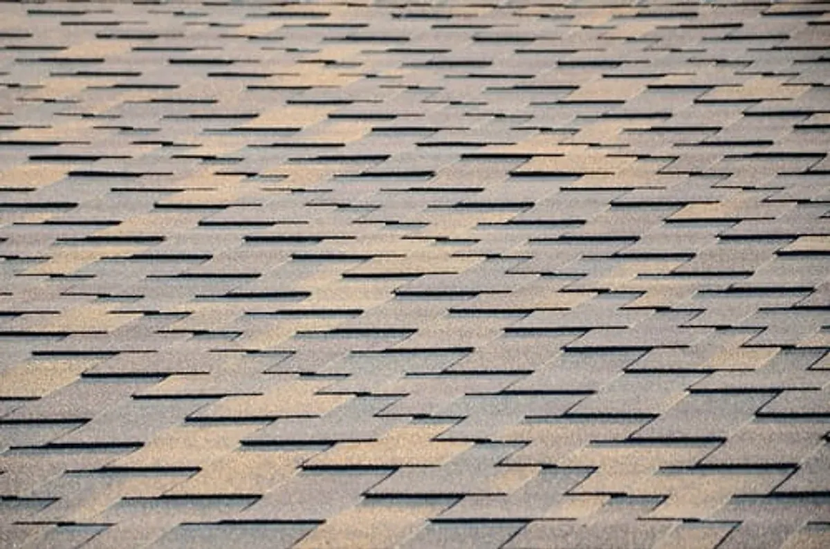 Aging asphalt shingle roof on a Georgia home showing wear and granule loss