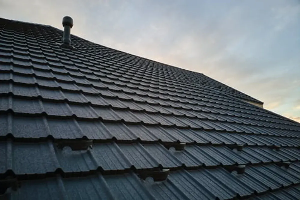 Completed dark tile roof restoration by I and G Construction Inc in Georgia