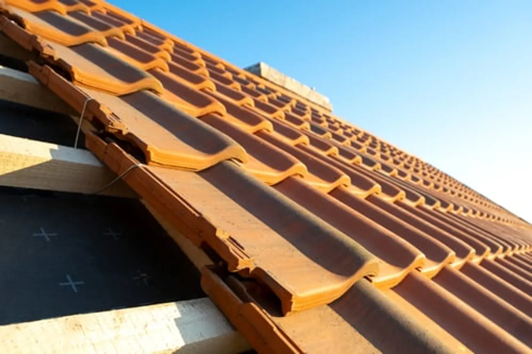 Well-maintained tile roof under a blue Georgia sky