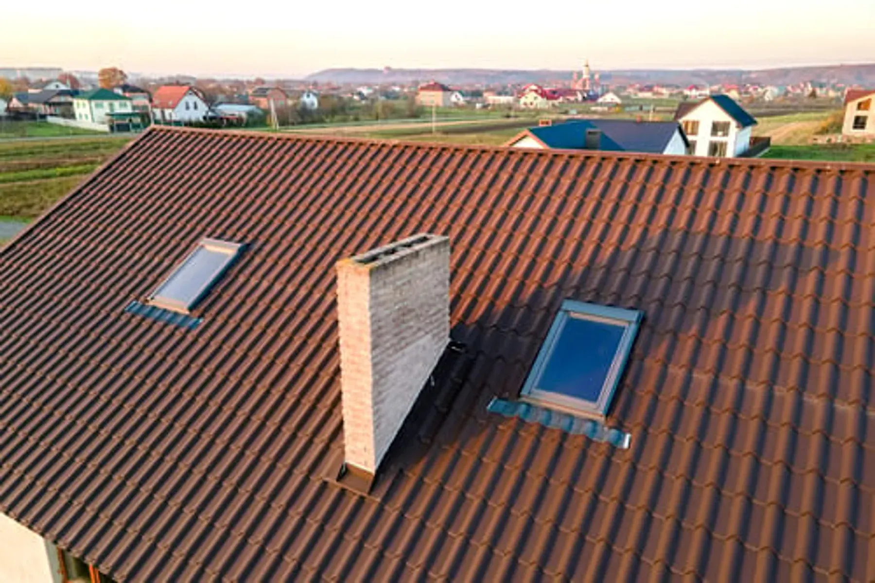Tile roof with skylights on a Georgia home overlooking a residential neighborhood